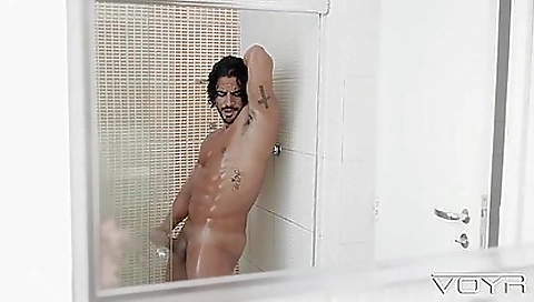 A sexy brunette with a tattooed body is playing with a dick